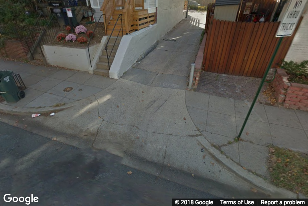 A Street View image of a side street not level with the sidewalk