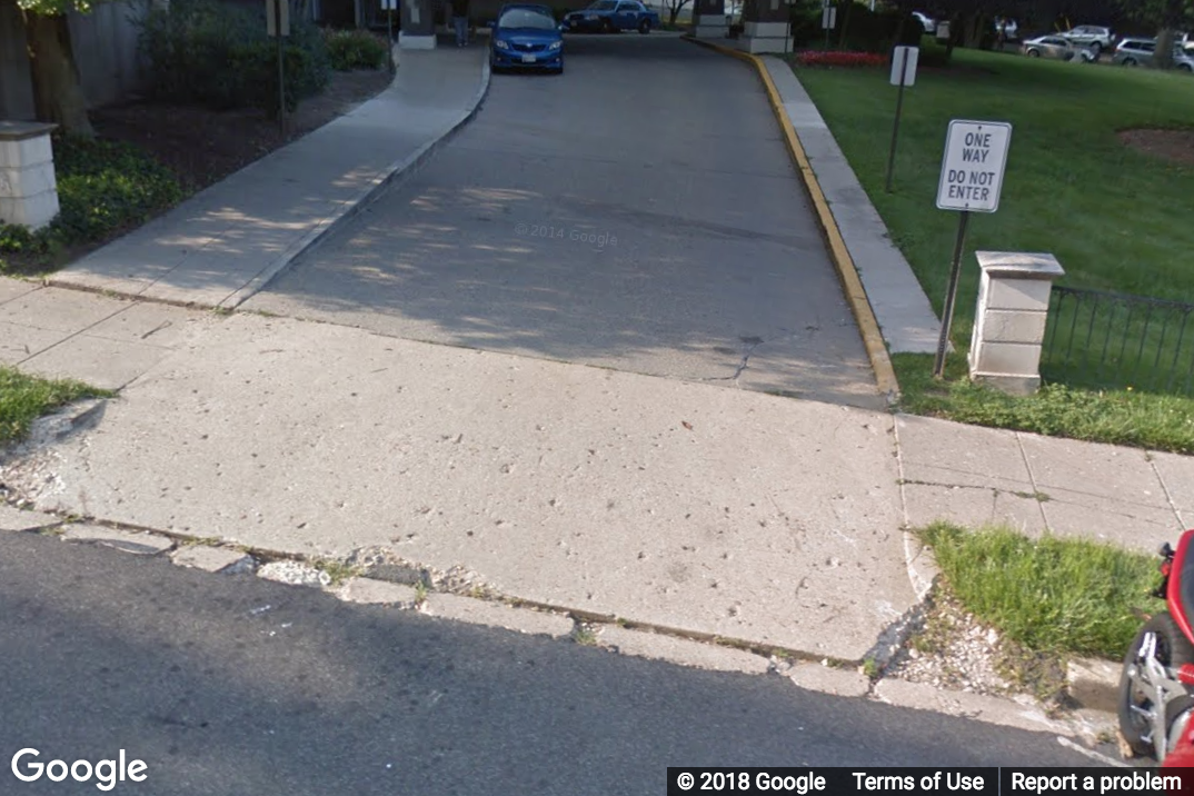A Street View image of a side street level with the sidewalk