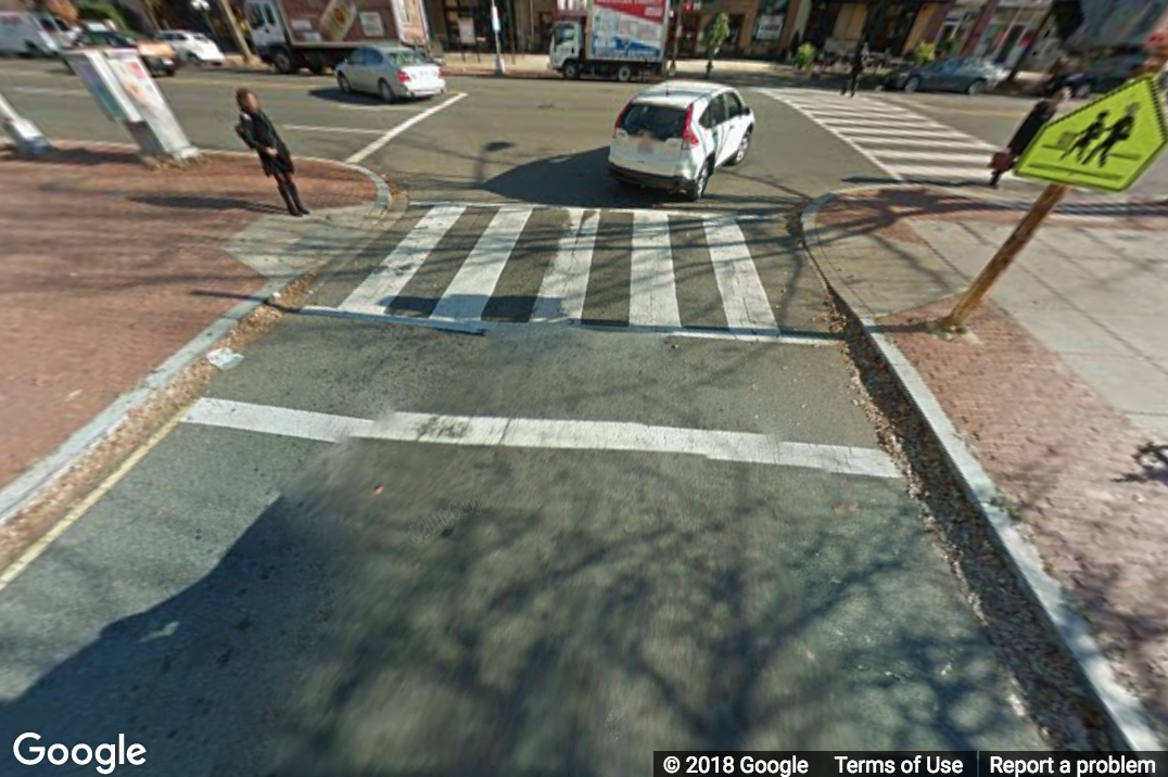 A Street View image of a crosswalk connecting two curb ramps