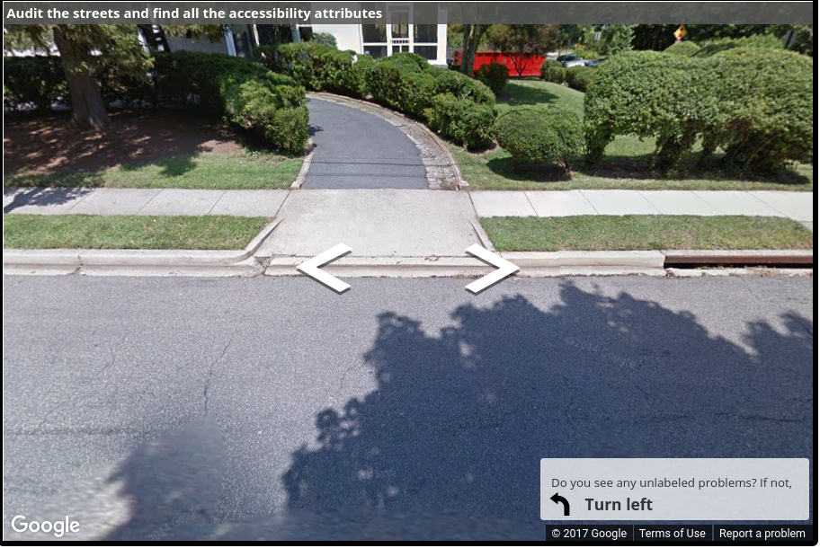 A Street View image of a driveway with a curb ramp