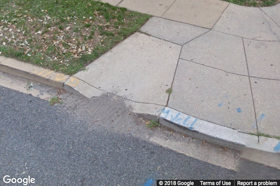 A Street View image of a narrow curb ramp