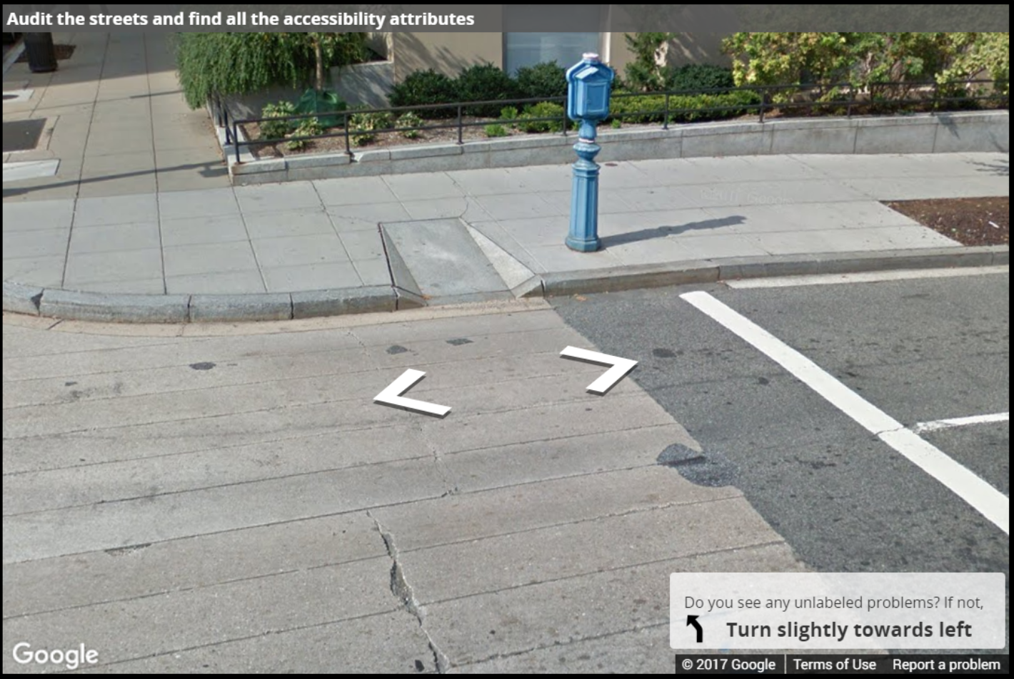A Street View image of a narrow curb ramp with steep sides with no tactile warning